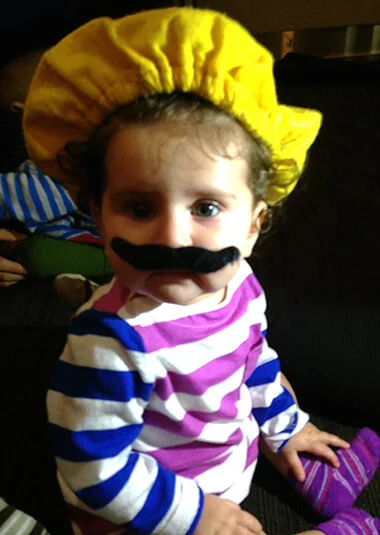 Child wearing a playful mustache